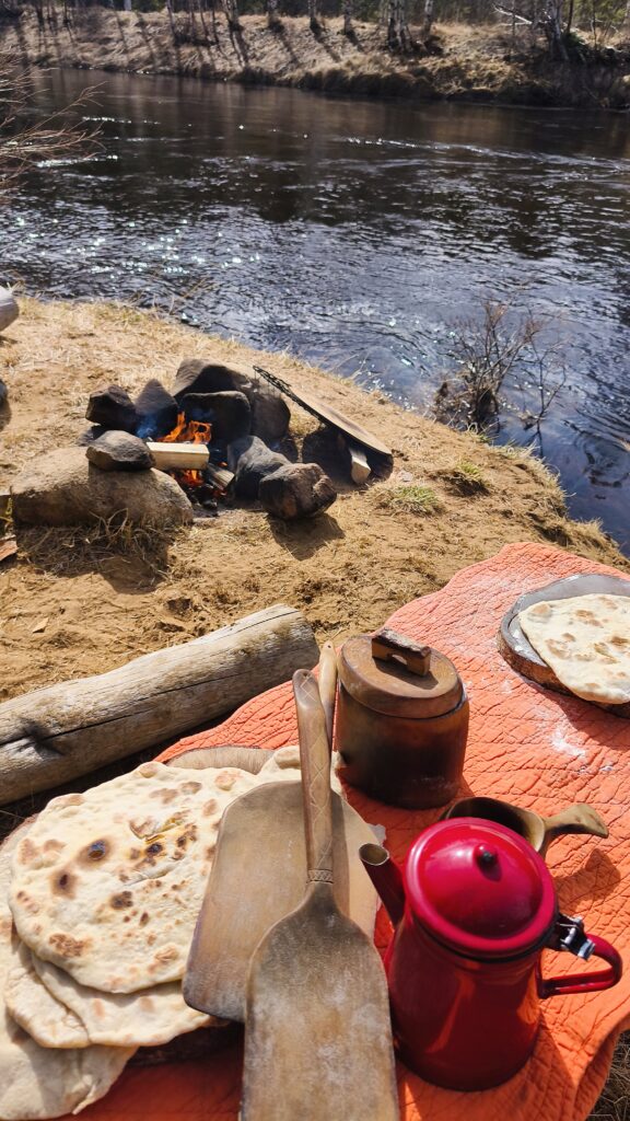 campfire in northern sweden with a kuksa cup handmade by witaberget