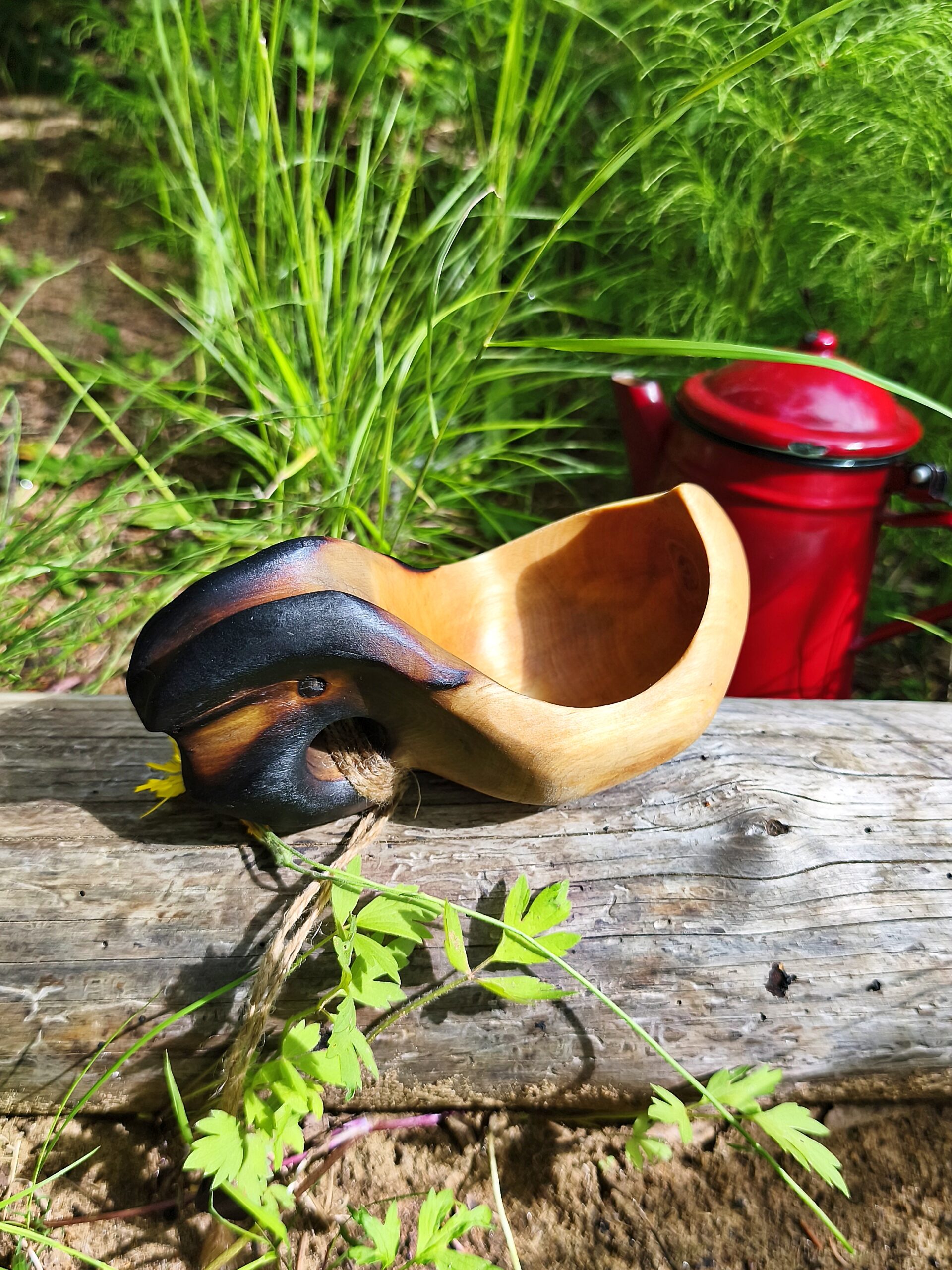 traditional Nordic Kuksa cup handcrafted from untreated birch wood in Sweden for outdoor adventures.